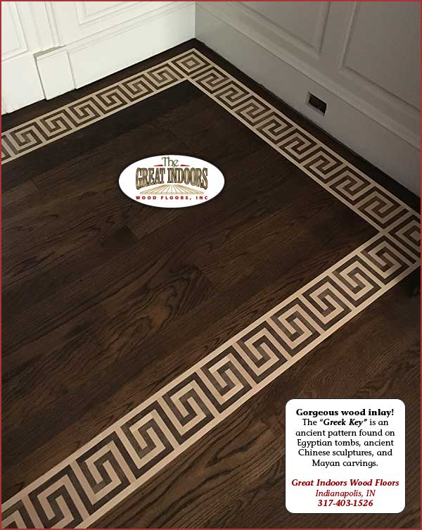 greek key inlay pattern of dark wood in light hardwood floor