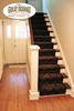 Wood floors in hallway with entry and stairway