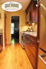 Elegant kitchen with light oak flooring and dark wood cabinets