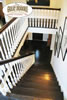 Elegant hardwood stair treads on this stairway are accented by the white newells
