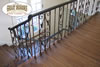Antique wrought iron stair rail with dark hardwood stair treads and landing