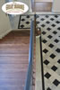 Hardwood stairway to checkerboard tile landing