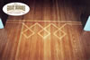 Artistic wood stain pattern on hardwood floor