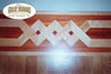 Wood mosaic fireplace border in hardwood floor